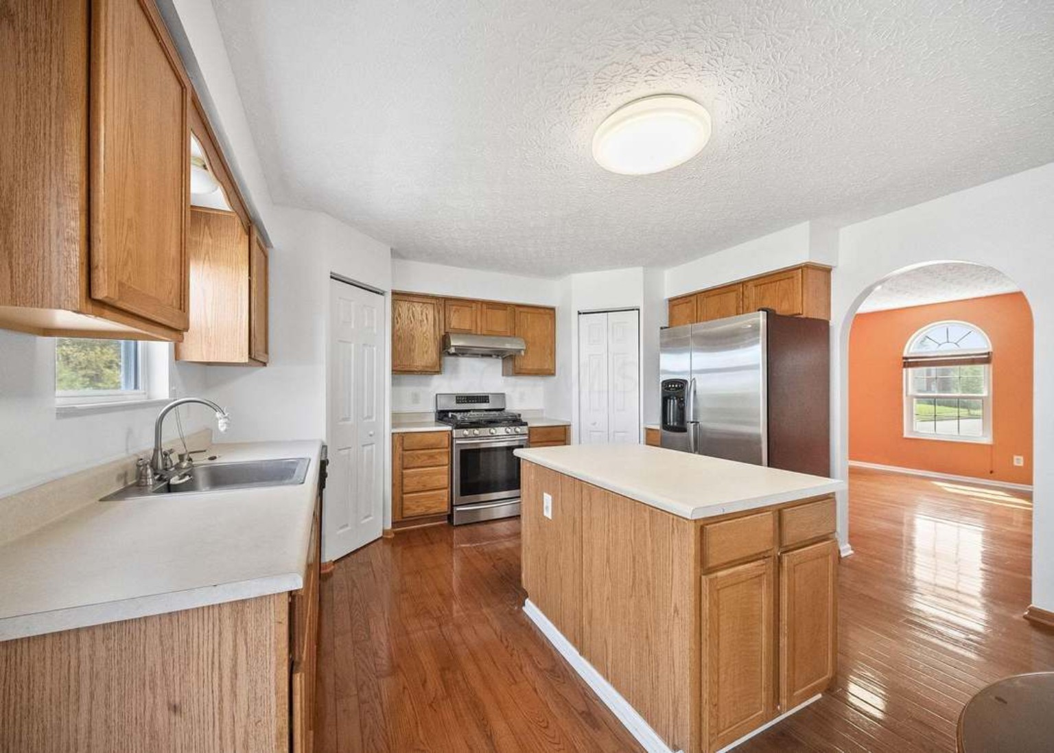 Kitchen with center island and hardwood floors